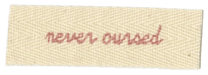 a fabric tab that says 'never cursed' on it like the tab from
                                                     phantom thread