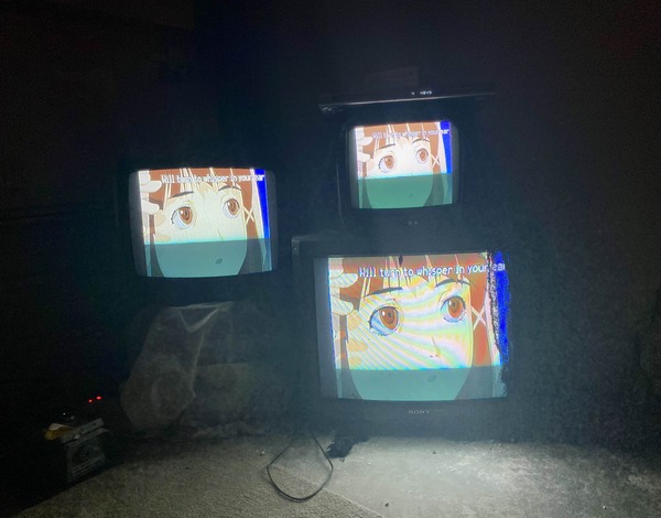 three CRTs playing the lain anime. lain is looking to her
                                                       left